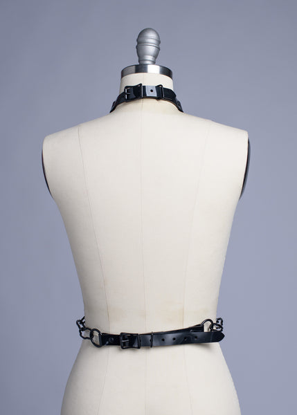 Black cathedral chain body harness belt displayed on a dress form.