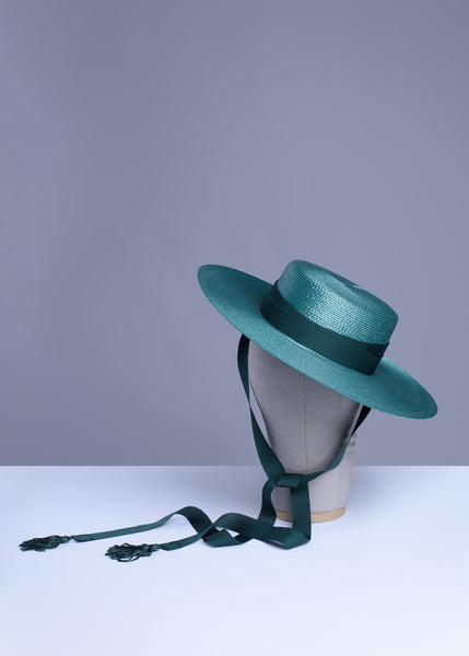 Deep teal green wide brim hat with green grosgrain ribbon ties and tassels.
