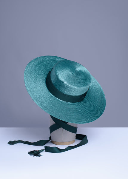 Deep teal green wide brim hat with green grosgrain ribbon ties and tassels.