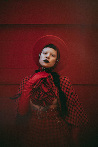 Red Apatico harness hat, red and black houndstooth fashion by Samantha Rei, photography by Emma Wondra, editorial inspired by Alexander McQueen.