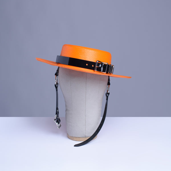 Apatico harness hat in orange with black pvc buckle band and harness chin straps, perfect spooky halloween vibes