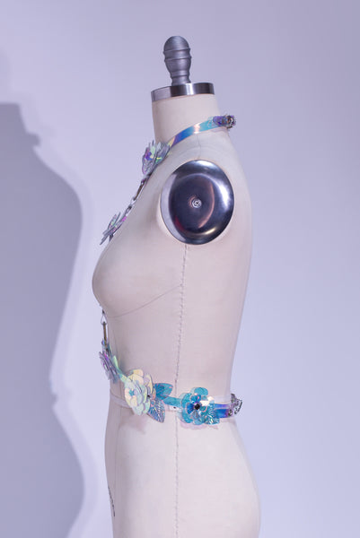 Rainbow, iridescent, holographic roses fashion  harness. Ornate, sculptural, three-dimentional floral harness displayed on a professional dressform.