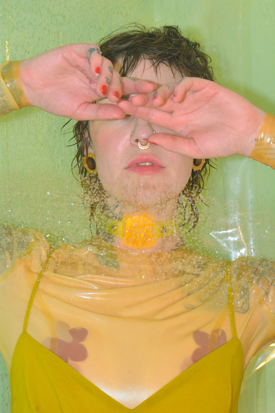 Katrina wears a neon yellow lemon citrus choker by Apatico and Anhedonie while wearing a yellow latex top and yellow dress.