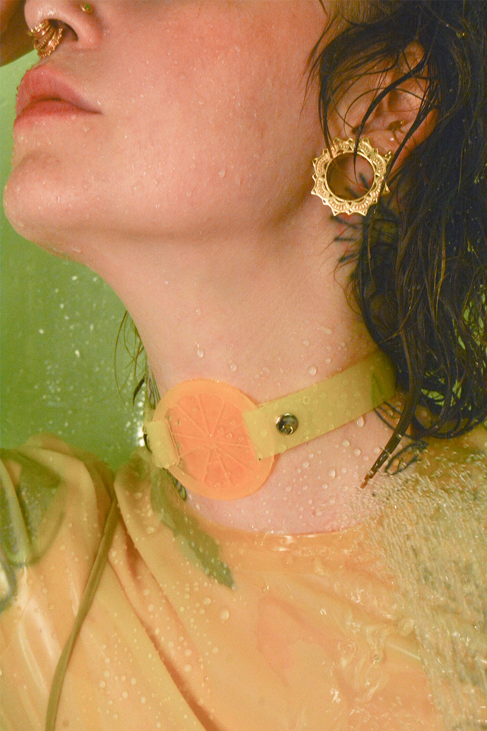 Katrina wears a neon yellow lemon citrus choker by Apatico and Anhedonie while wearing a yellow latex top and yellow dress.