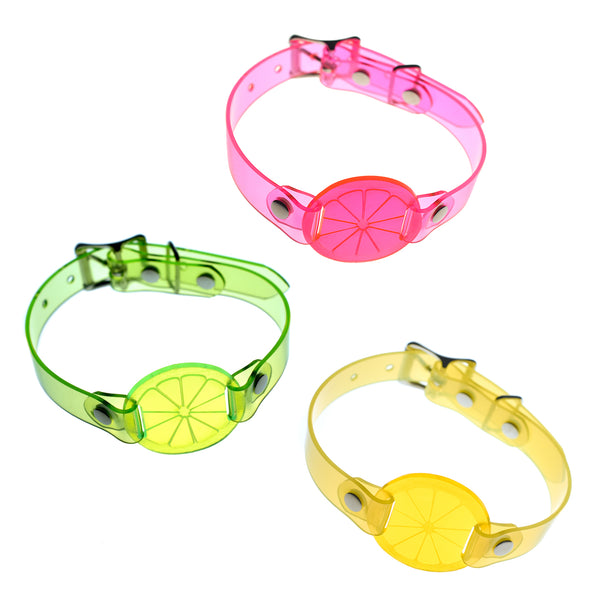 Apatico and Anhedonie choker collar necklaces in neon uv green, pink, and yellow with acrylic citrus centers.