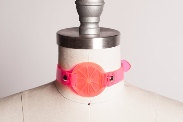 Apatico and Anhedonie choker collar in neon uv pink with acrylic citrus center.