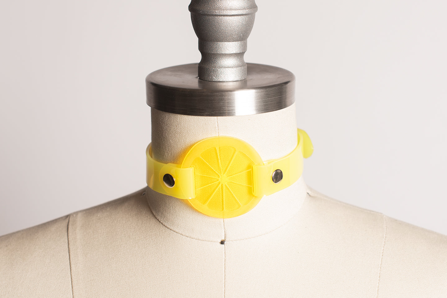 Apatico and Anhedonie choker collar in neon uv yellow with acrylic citrus center.