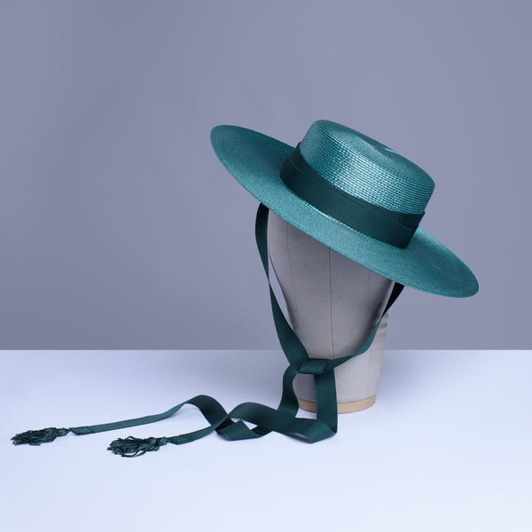 Deep teal green wide brim hat with green grosgrain ribbon ties and tassels.