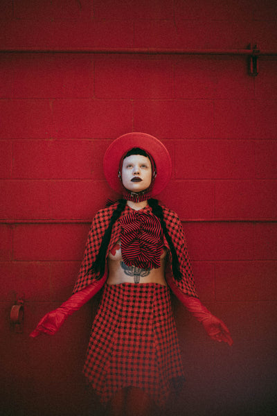 Red Apatico harness hat, red and black houndstooth fashion by Samantha Rei, photography by Emma Wondra, editorial inspired by Alexander McQueen.