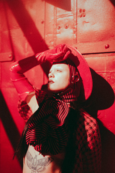 Red Apatico harness hat, red and black houndstooth fashion by Samantha Rei, photography by Emma Wondra, editorial inspired by Alexander McQueen.