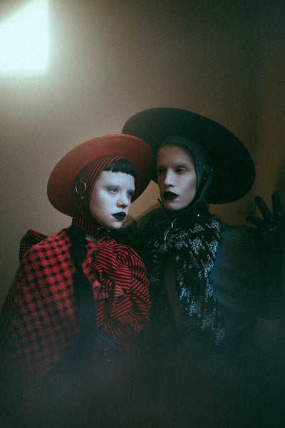 Red Apatico harness hat, red and black houndstooth fashion by Samantha Rei, photography by Emma Wondra, editorial inspired by Alexander McQueen.