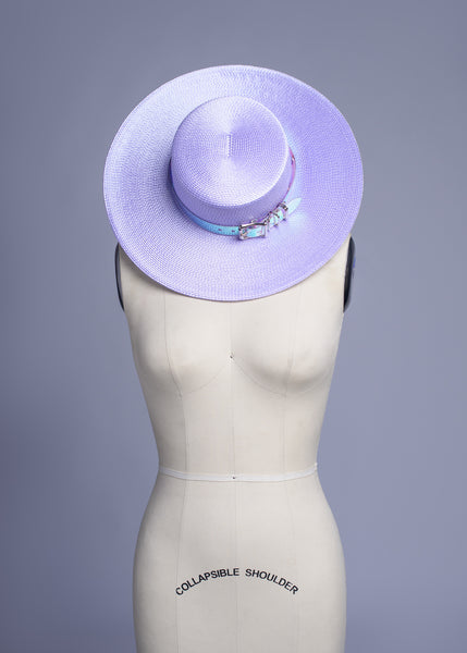 Apatico wide brim harness hat in pastel lavender with an iridescent, holographic pvc buckle band and harness straps.