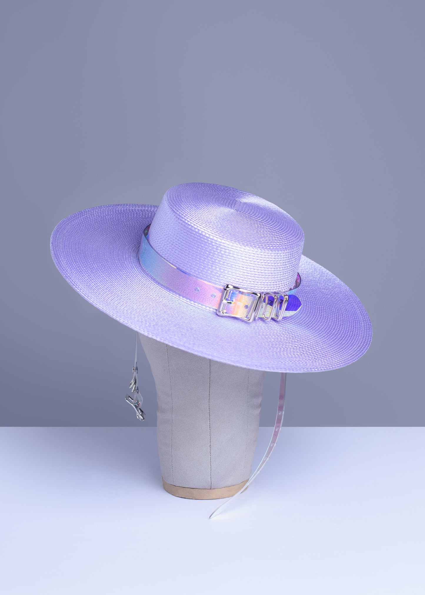 Apatico wide brim harness hat in pastel lavender with an iridescent, holographic pvc buckle band and harness straps.