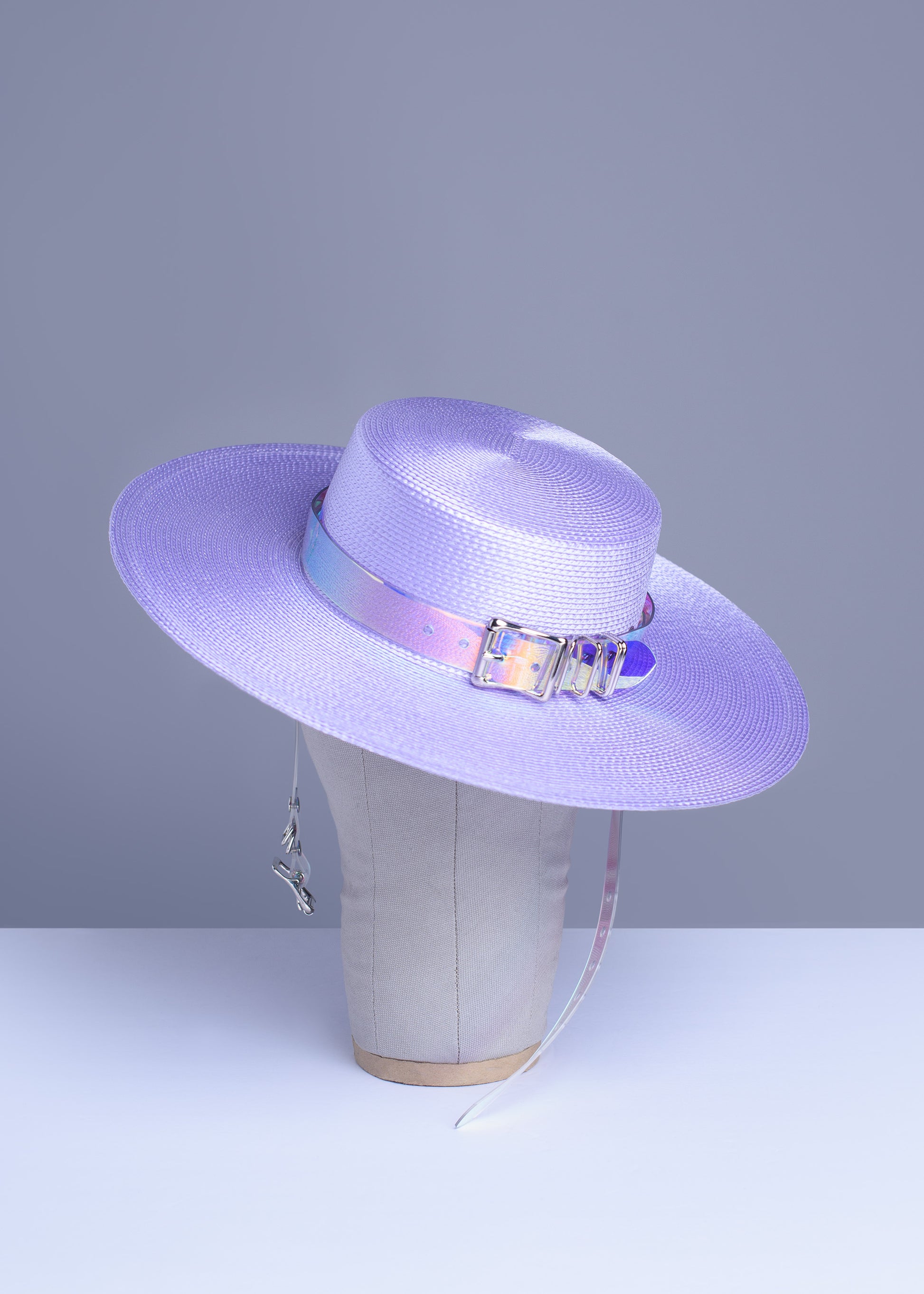 Apatico wide brim harness hat in pastel lavender with an iridescent, holographic pvc buckle band and harness straps.