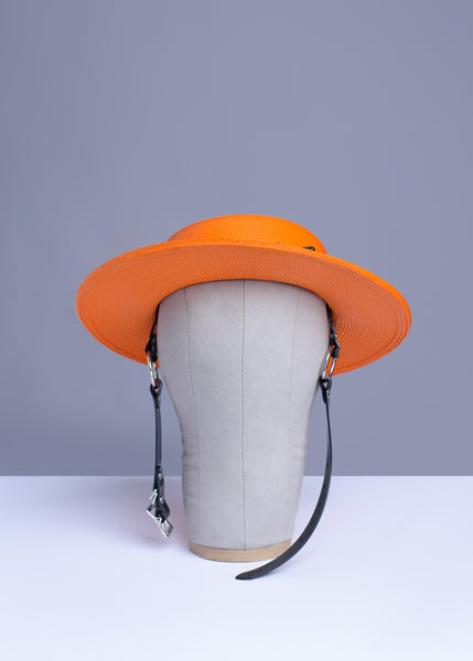 Apatico harness hat in orange with black pvc buckle band and harness chin straps, perfect spooky halloween vibes