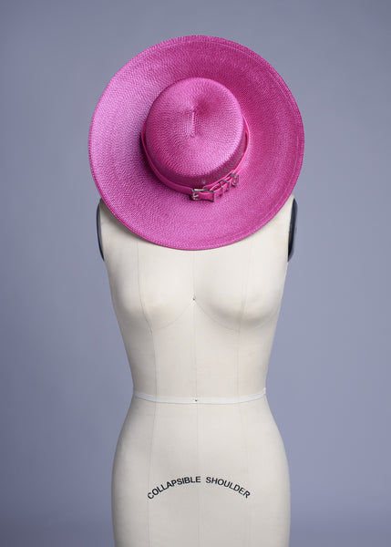 Fuchsia magenta pink harness hat with pink buckle band, displayed on a dress form mannequin.
