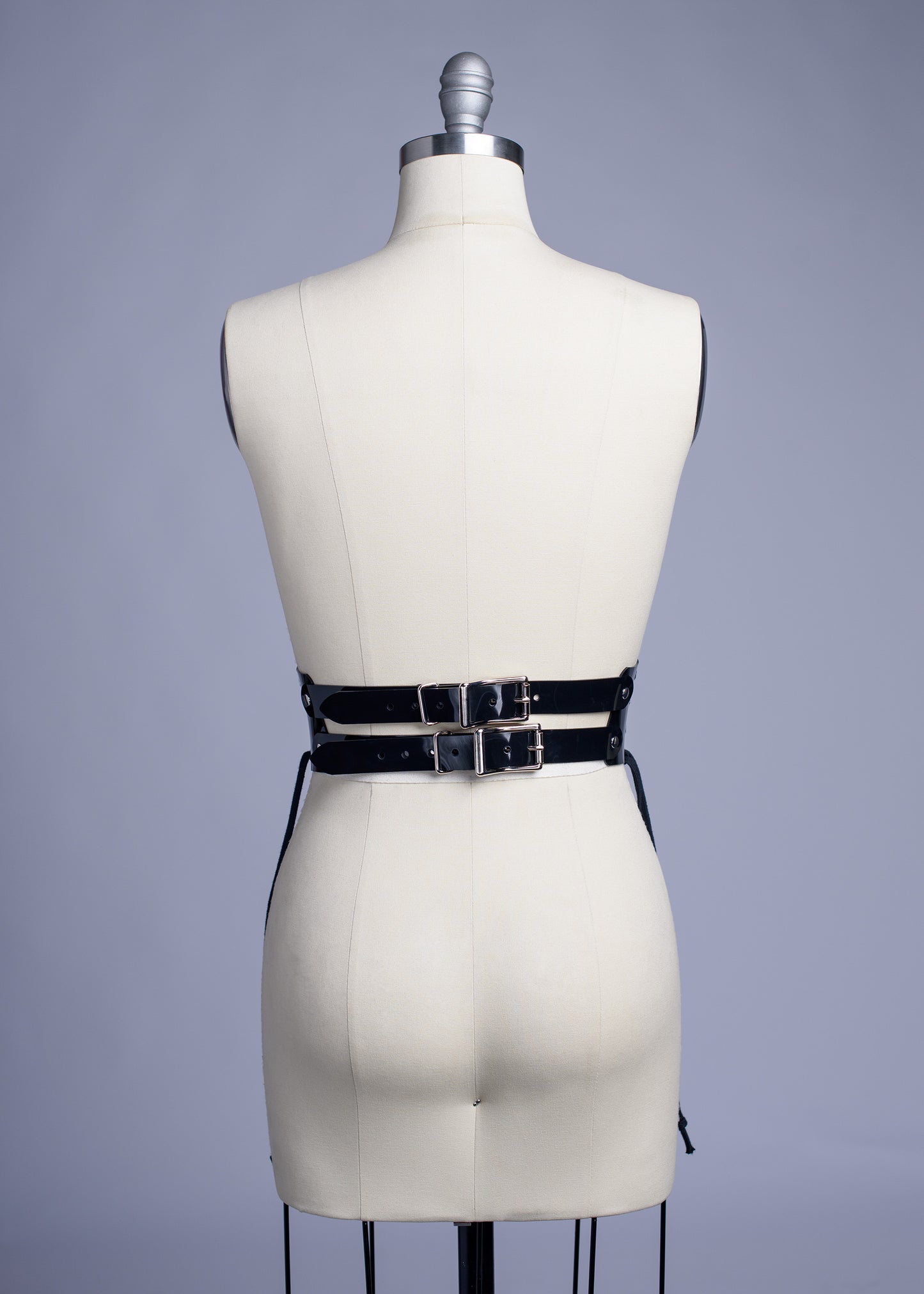 Black PVC lace up Corset style waist belt displayed on dress form.