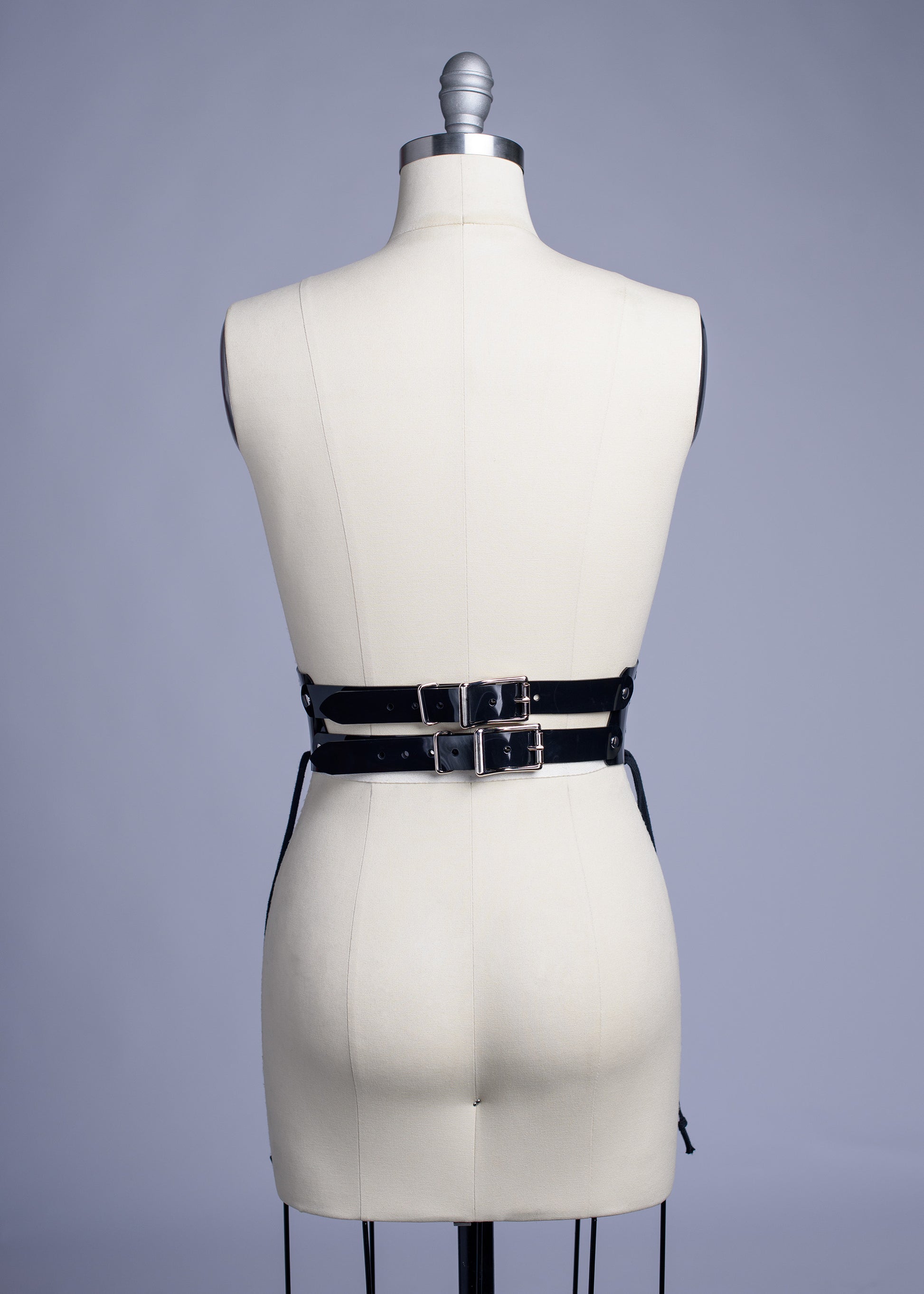 Black PVC lace up Corset style waist belt displayed on dress form.