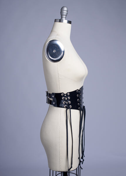 Black PVC lace up Corset style waist belt displayed on dress form.