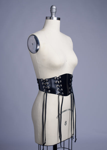 Black PVC lace up Corset style waist belt displayed on dress form.