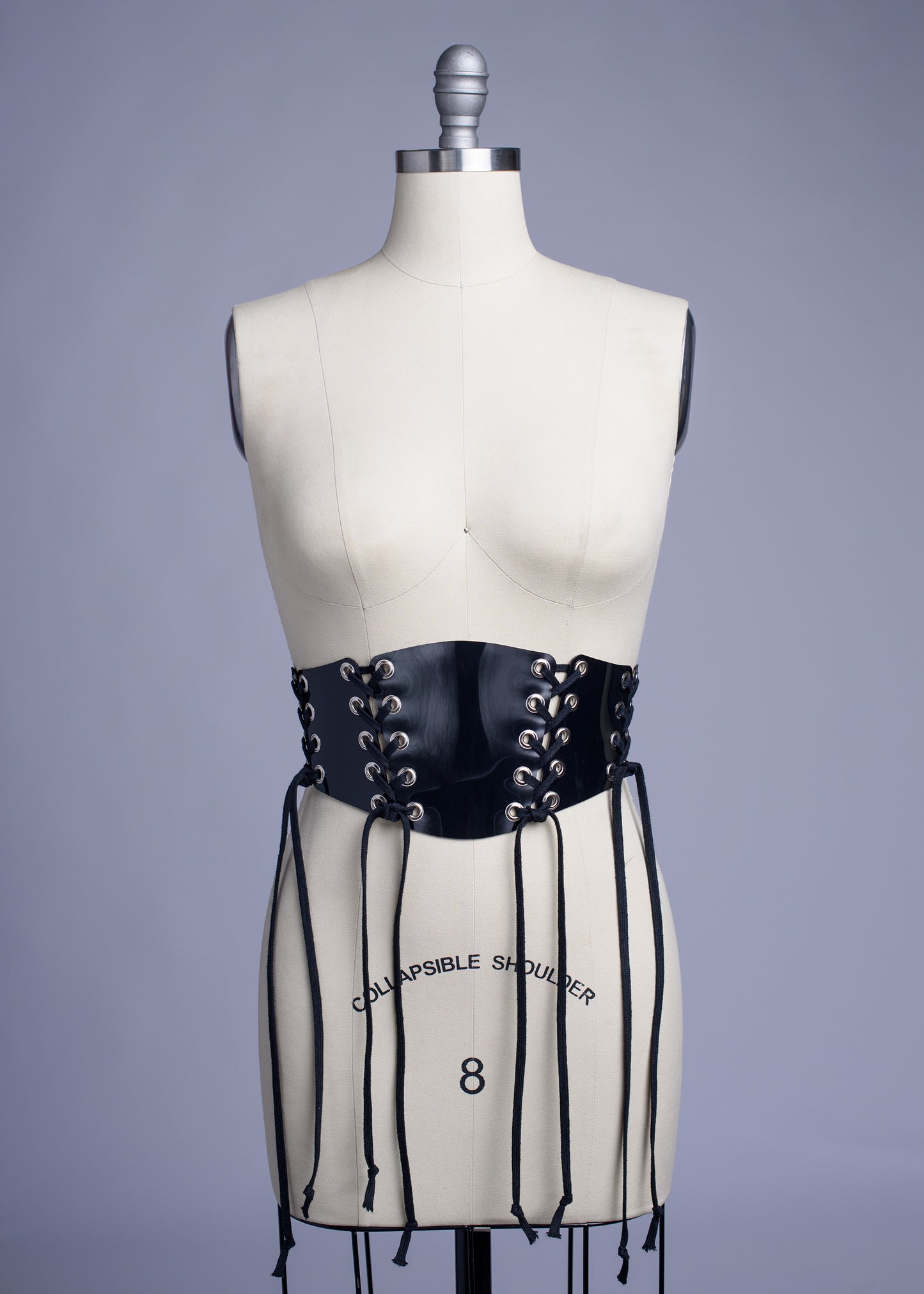 Black PVC lace up Corset style waist belt displayed on dress form.