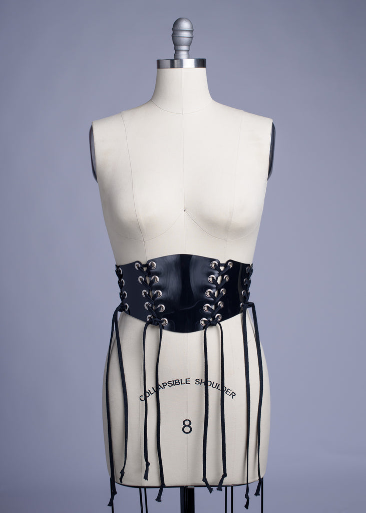 Black PVC lace up Corset style waist belt displayed on dress form.