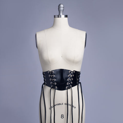 Black PVC lace up Corset style waist belt displayed on dress form.