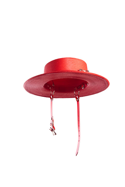Red wide brim faux straw hat with translucent red pvc harness strap details.