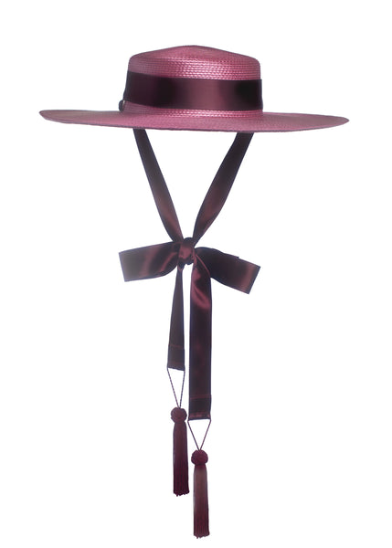 Apatico dusty mauve pink wide brim straw hat with burgundy satin ribbon ties and tassels.